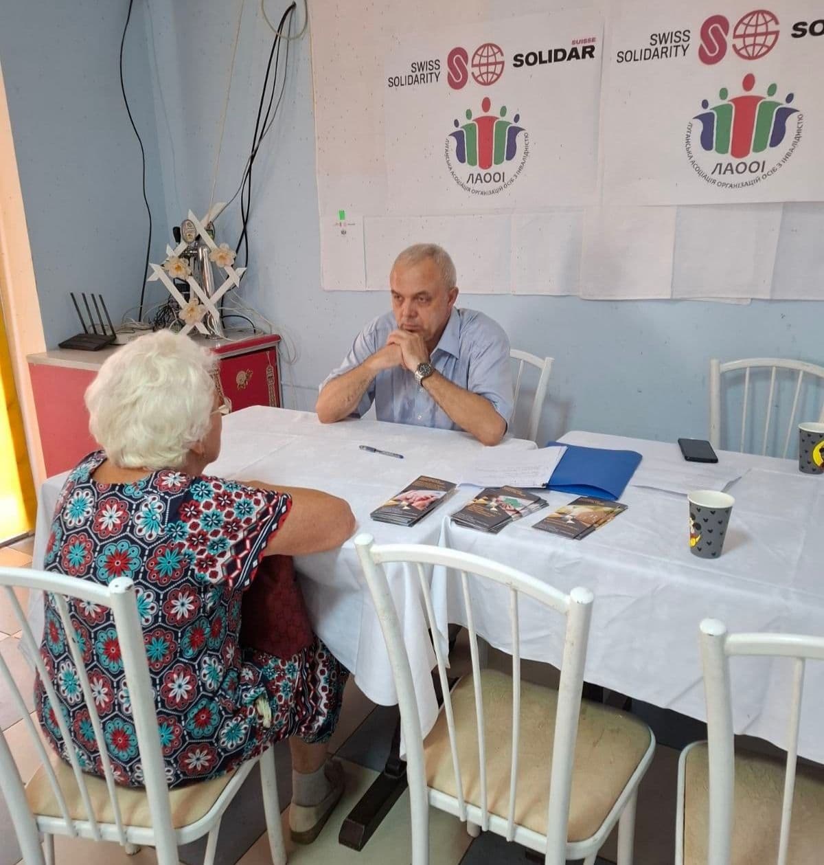 A man and a woman are sitting at the table across from each other.